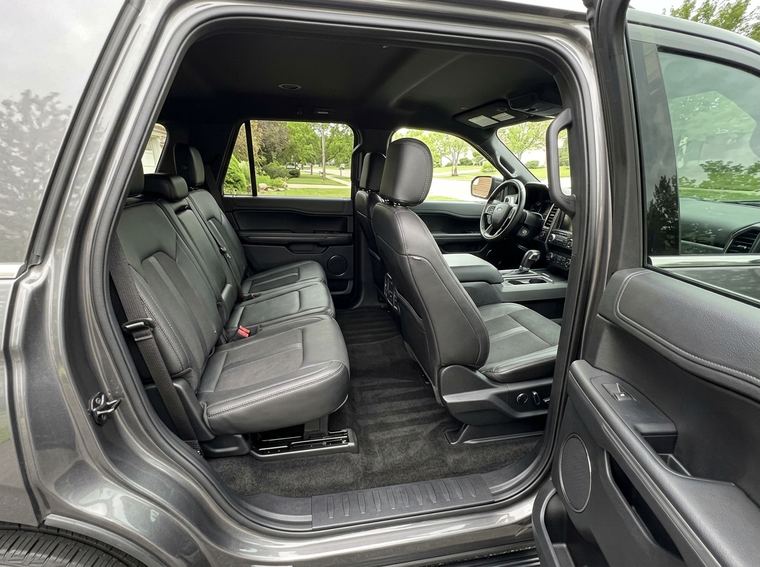 Three row SUV interior after a deep clean, vacuum lines in the carpet and spotless seats